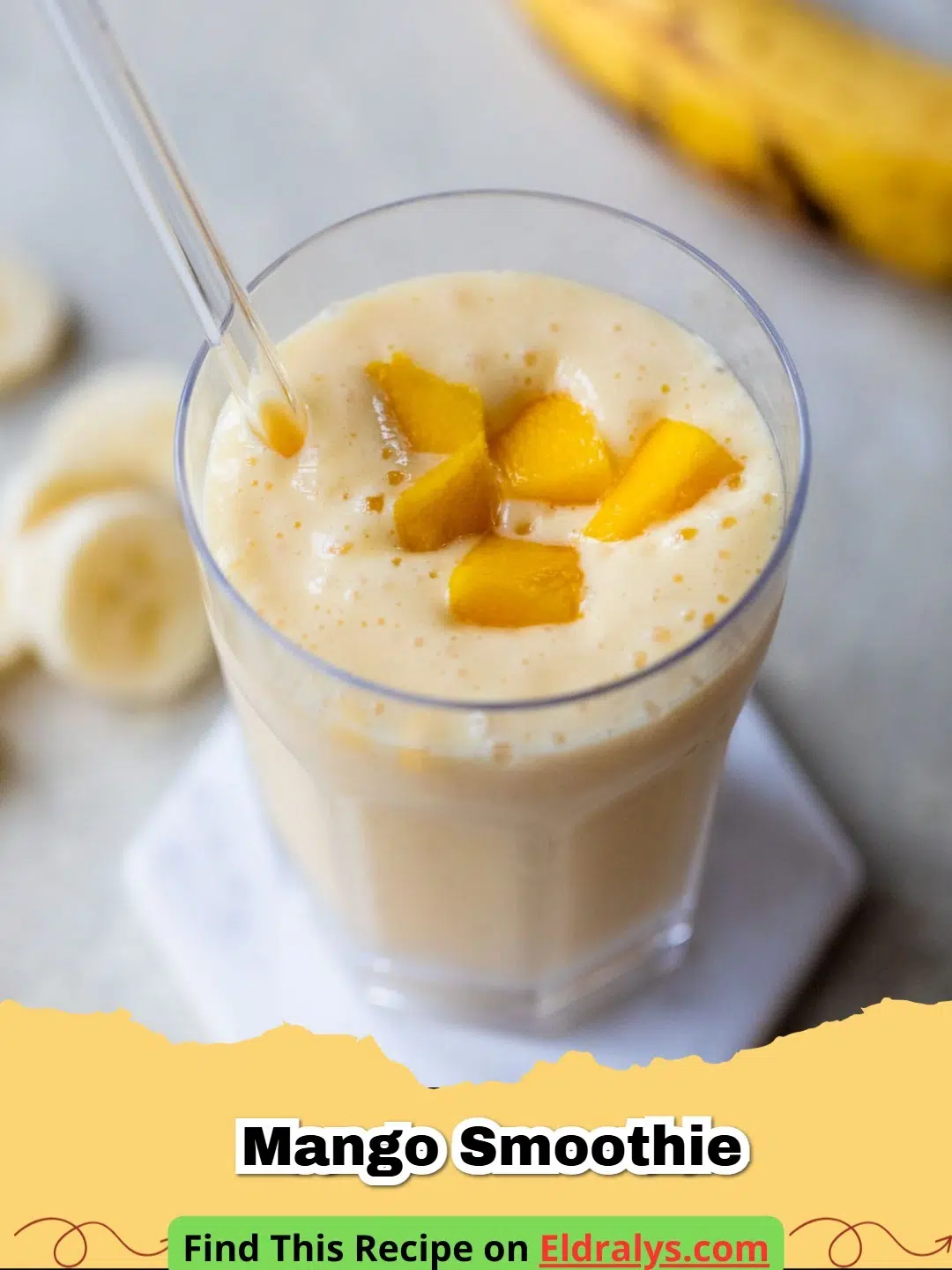 A vibrant yellow Mango Smoothie in a glass with a mint garnish
