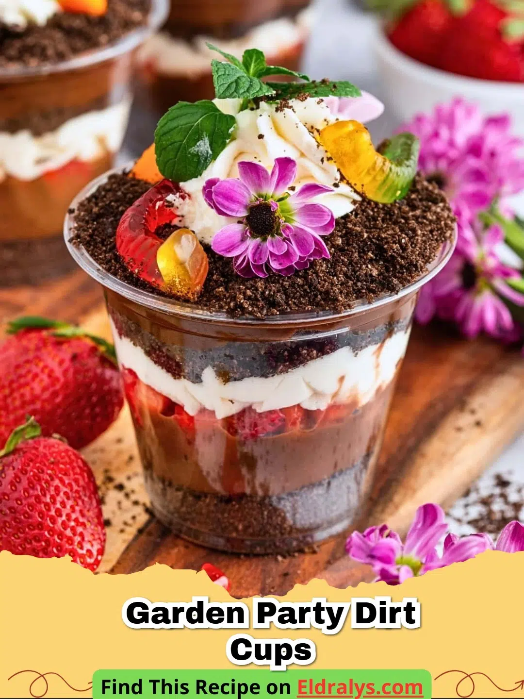 Garden Party Dirt Cups topped with edible flowers and mint leaves in small glass jars.